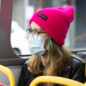Photograph of bus passenger wearing a medical face-mask.