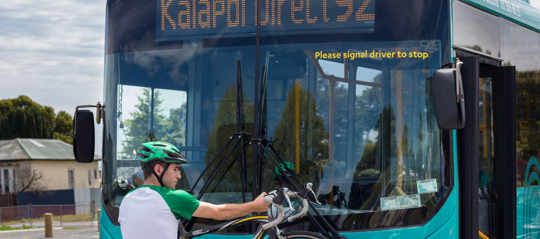 Passenger putting bike on bike rack on Kaiapoi Direct 92 bus
